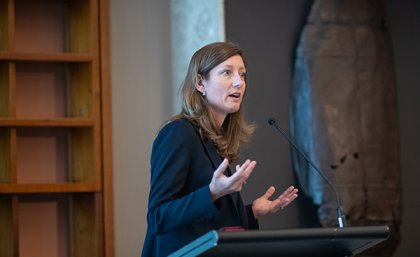 Professor Nicole Gillespie presenting at UQ 's Trust, Ethics and Governance Alliance Symposium (2020) Professor Nicole Gillespie speaking at a podium
